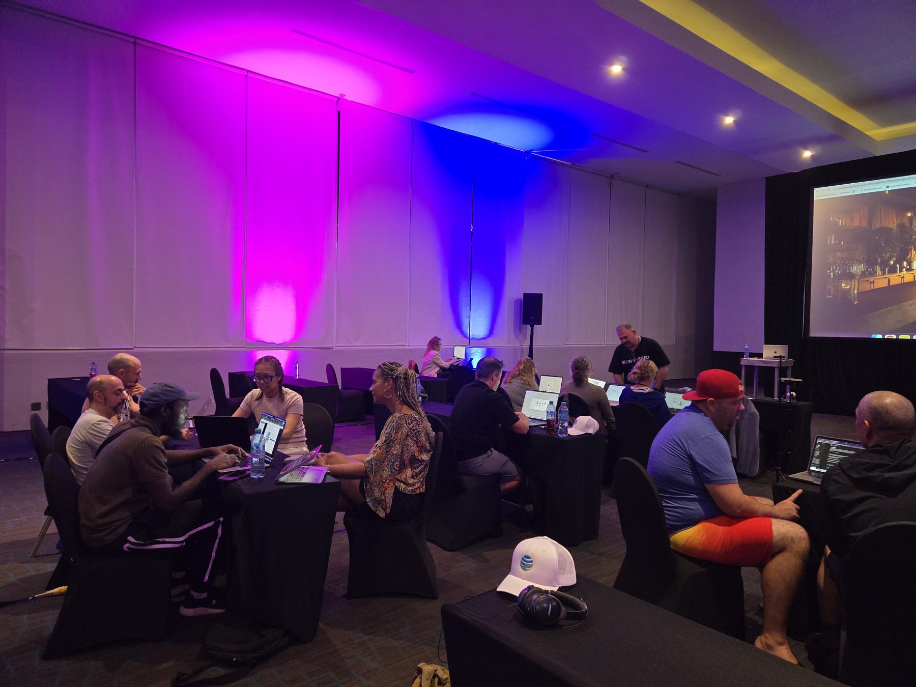 Members building on their laptops at an AIU live in-person intensive